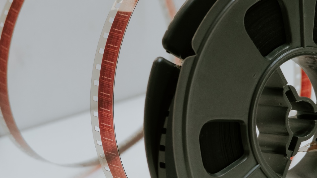 A film reel unspooling on a white background